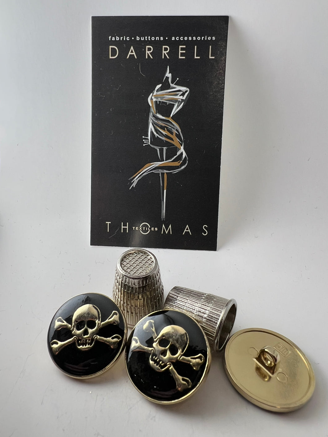 Gold & Black Enamel Covered Skull & Crossbones Button