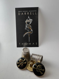 Gold & Black Enamel Covered Skull & Crossbones Button